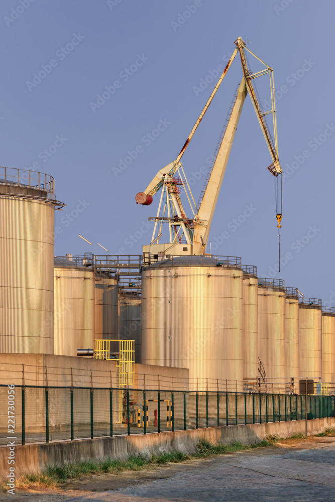 Silos at an oil refinery late afternoon, Port of Antwerp, Belgium. Silos at an oil refinery late afternoon, Port of Antwerp, Belgium.