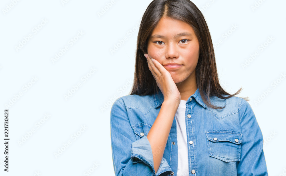 Young asian woman over isolated background thinking looking tired and bored with depression problems with crossed arms. Young asian woman over isolated background thinking looking tired and bored with depression problems with crossed arms.