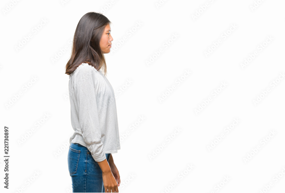 Young asian woman over isolated background looking to side, relax profile pose with natural face with confident smile.