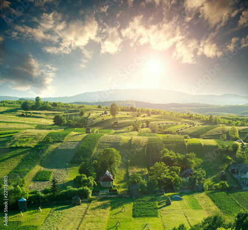 Aerial view of rural pastures on hills at dawn sky