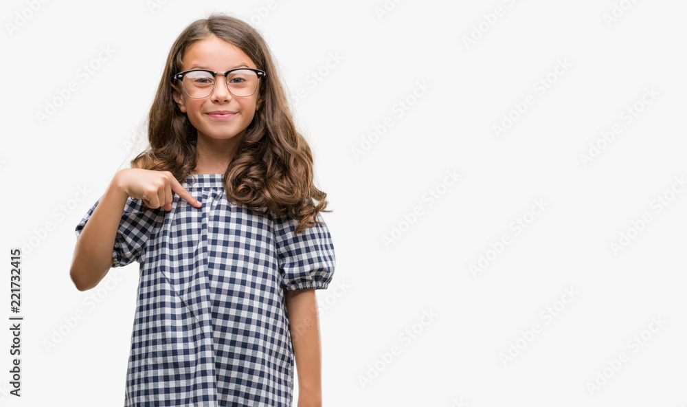 Brunette hispanic girl wearing glasses with surprise face pointing finger to himself Brunette hispanic girl wearing glasses with surprise face pointing finger to himself