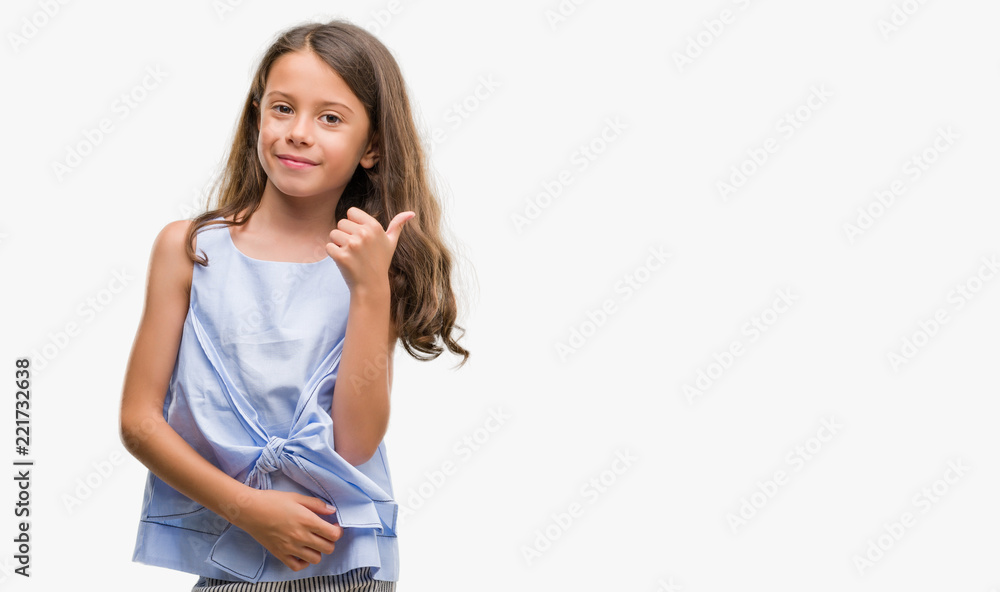 Brunette hispanic girl doing happy thumbs up gesture with hand. Approving expression looking at the camera with showing success. Brunette hispanic girl doing happy thumbs up gesture with hand. Approving expression looking at the camera with showing success.