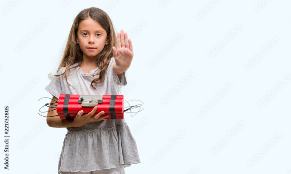 Brunette hispanic girl holding a bomb with open hand doing stop sign with serious and confident expression, defense gesture Brunette hispanic girl holding a bomb with open hand doing stop sign with serious and confident expression, defense gesture