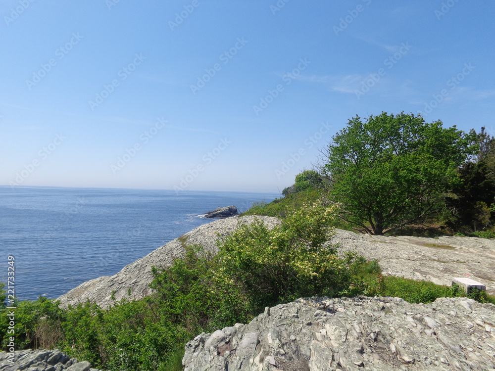 Scenic view of sky, rocks, and water on a spring day.    

