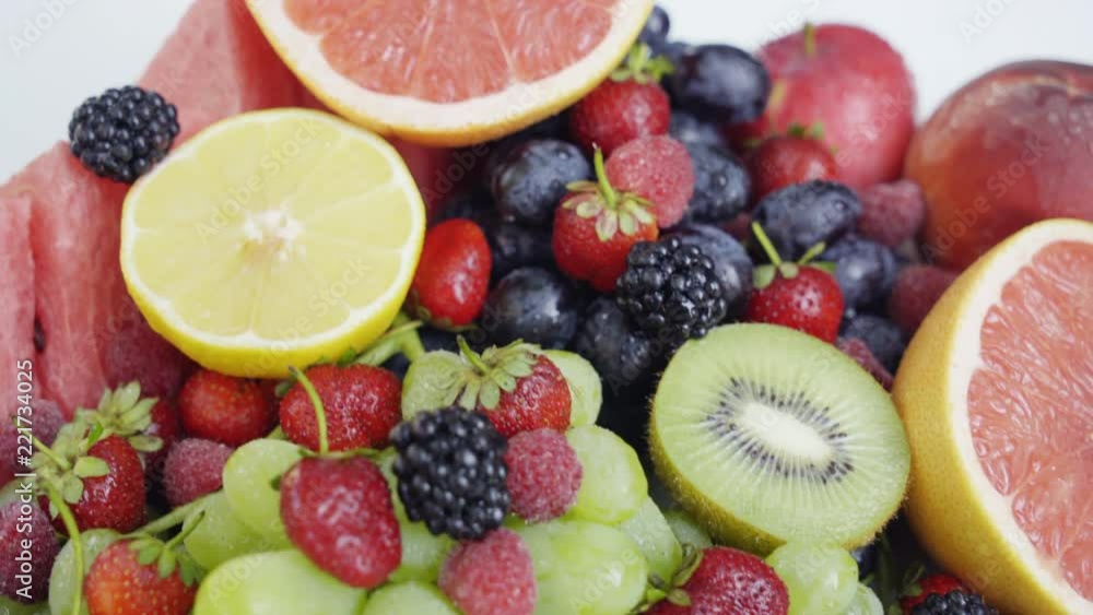 Beautiful mixed berries and fruit on white background. Close up healthy food. 4K Beautiful mixed berries and fruit on white background. Close up healthy food. 4K