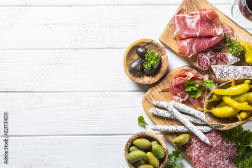 Obraz na płótnie Italian antipasto with salami, jamon and olives on white.