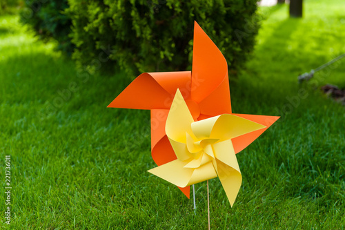 Bright paper pinwheel decoration at party outdoors photo