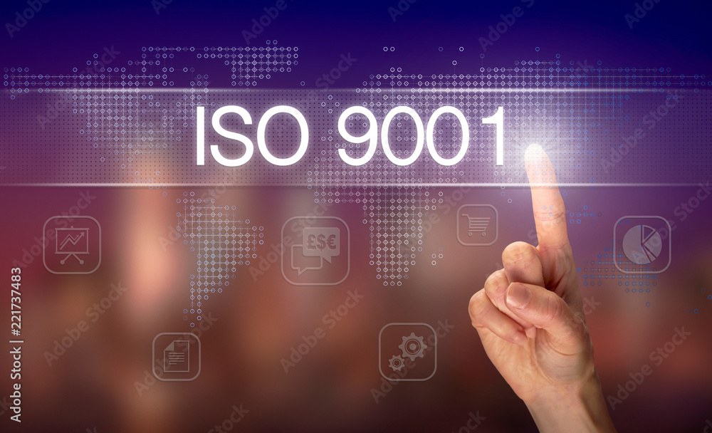 A hand selecting a ISO 9001 business concept on a clear screen with a colorful blurred background. A hand selecting a ISO 9001 business concept on a clear screen with a colorful blurred background.