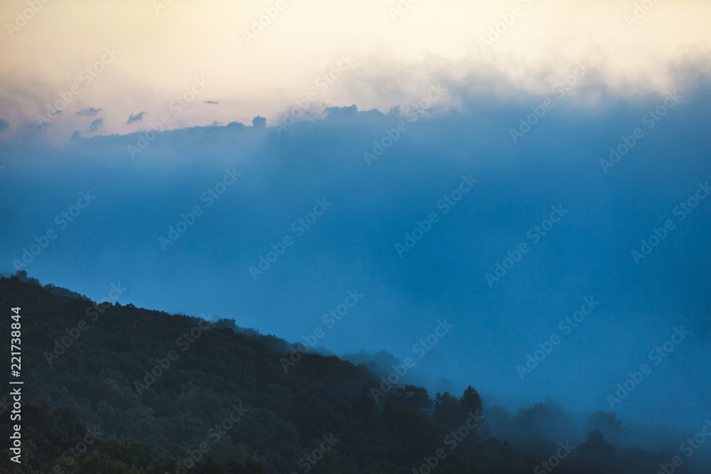 Morning fog settles between a valley in Shenandoah National Park, VA as the sunrises.