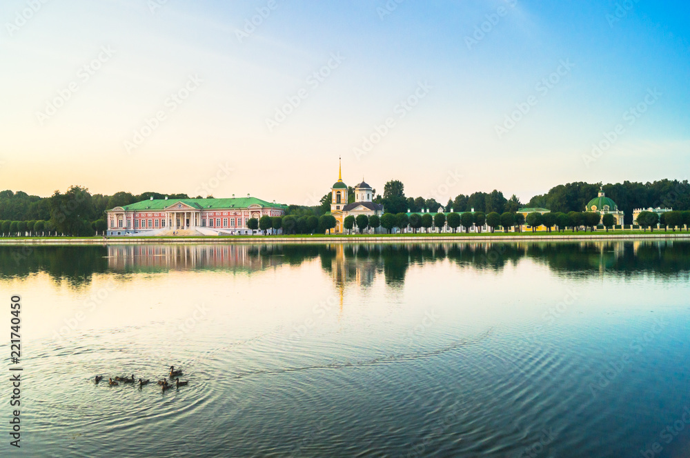 Evening serenity of the palace pond, included into ensemble of the State reserve museum Kuskovo, former aristocratic summer country estate of the russian nobility of the 18th century. Moscow. Russia. Evening serenity of the palace pond, included into ensemble of the State reserve museum Kuskovo, former aristocratic summer country estate of the russian nobility of the 18th century. Moscow. Russia.
