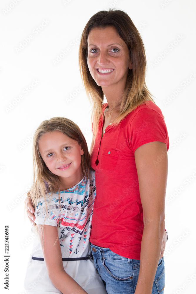 Beautiful young woman with her little cute daughter are standing on white background Beautiful young woman with her little cute daughter are standing on white background