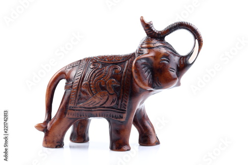 Brown Engraved pattern gold elephant made of resin like wooden carving with white ivory. Stand on white background, Isolated, Art Model Thai Crafts, For decoration Like in the spa.