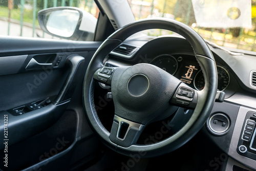 Closeup on car steering wheel, salon design