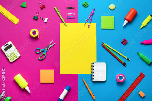Office supplies on a multi-colored background.