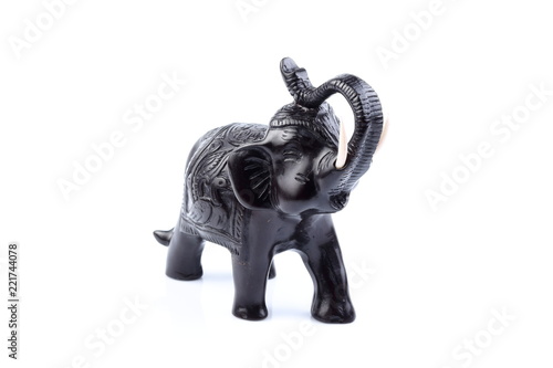 Black Engraved pattern gold elephant made of resin like wooden carving with white ivory. Stand on white background, Isolated, Art Model Thai Crafts, For decoration Like in the spa. © Thanachai