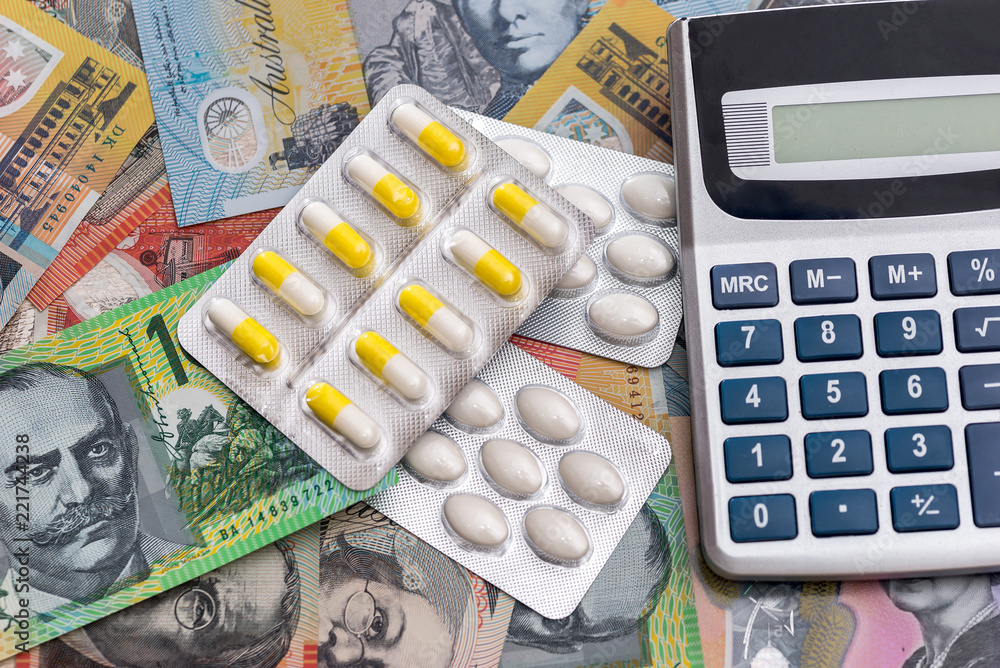 Pills with calculator on australian dollar banknotes Pills with calculator on australian dollar banknotes