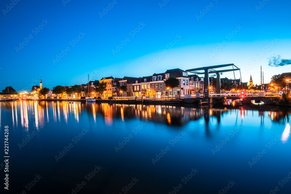 Fototapeta The old harbor with the beer quay and its 'accijnstoren' (Tax Tower) in Alkmaar. Made at sunset , bleu hour
