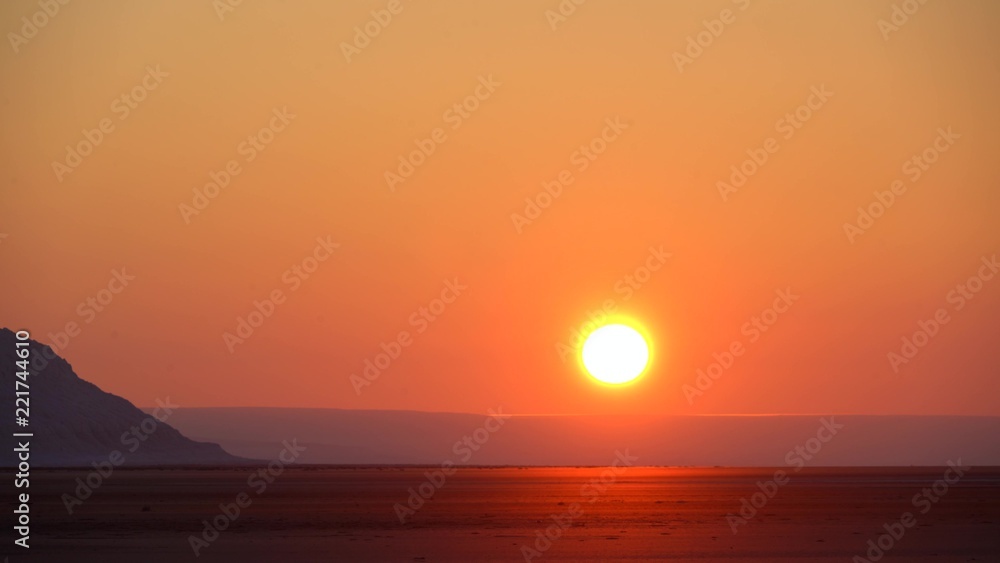 dawn in the desert, Red sun, mountains in the desert