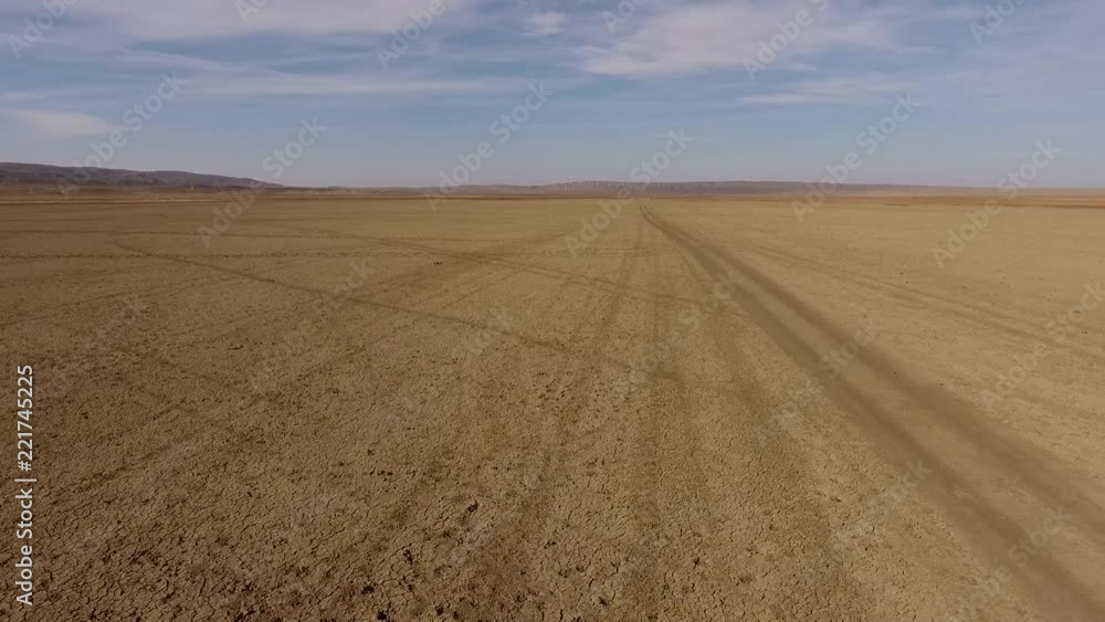 cars drive through the desert
