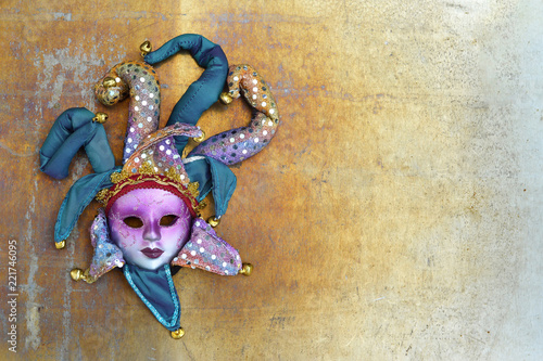 Venetian mask on grunge background with copy space. Flat lay carnival concept.