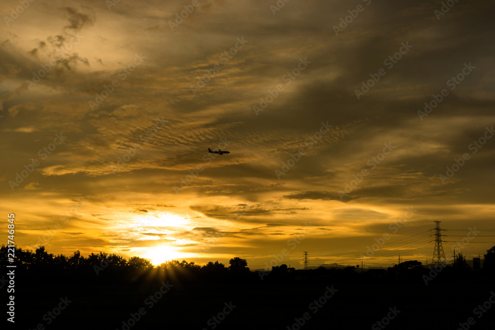 Airplane on the Electricity Pylon and beautiful sunset background Airplane on the Electricity Pylon and beautiful sunset background