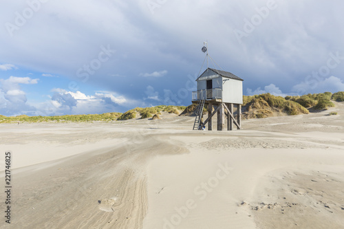 Shelter cabin on beach of Terschelling, Netherlands. Refuge for stranded castaways, in Dutch called 'drenkelingenhuisje'. photo