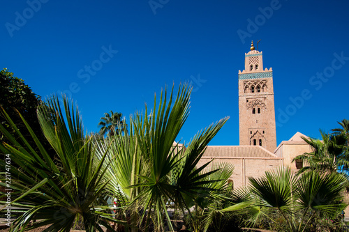 View of the Koutoubia mosque in Marrakesh with palm trees in the foreground