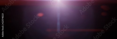 beautiful purple lens flare effect overlay texture with bokeh effect and anamorphic light streak in front of a black background banner