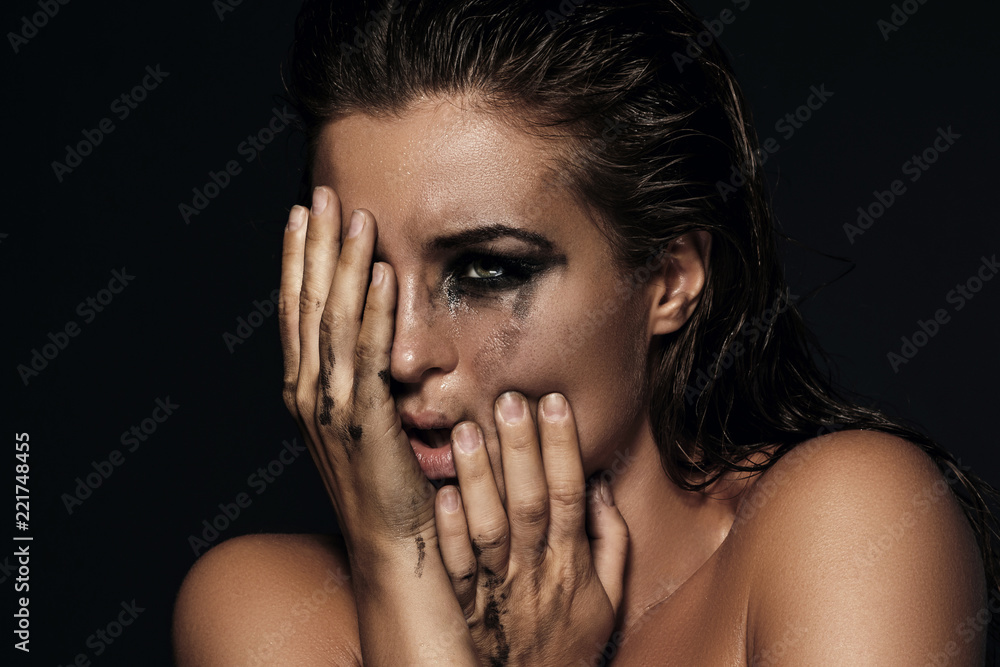 Beautiful woman with smudged makeup on her face Beautiful woman with smudged makeup on her face