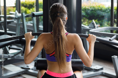 Woman doing exercise for her back - Lat pulldown