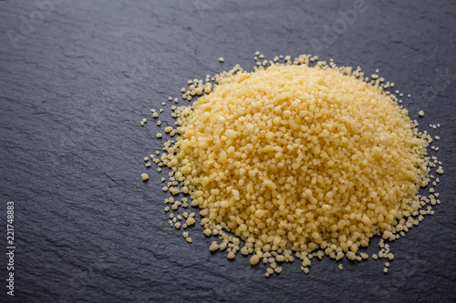 fresh couscous on a dark stone background photo