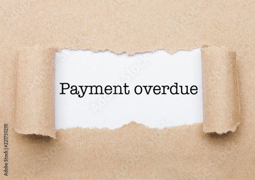 Payment Overdue text appearing behind brown paper