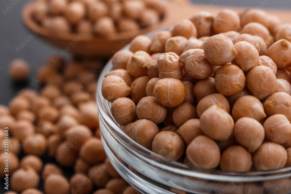 uncooked chickpeas on a dark stone background uncooked chickpeas on a dark stone background