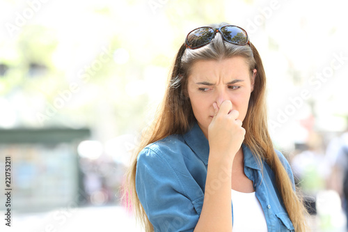 Girl covering nose in a contaminated city