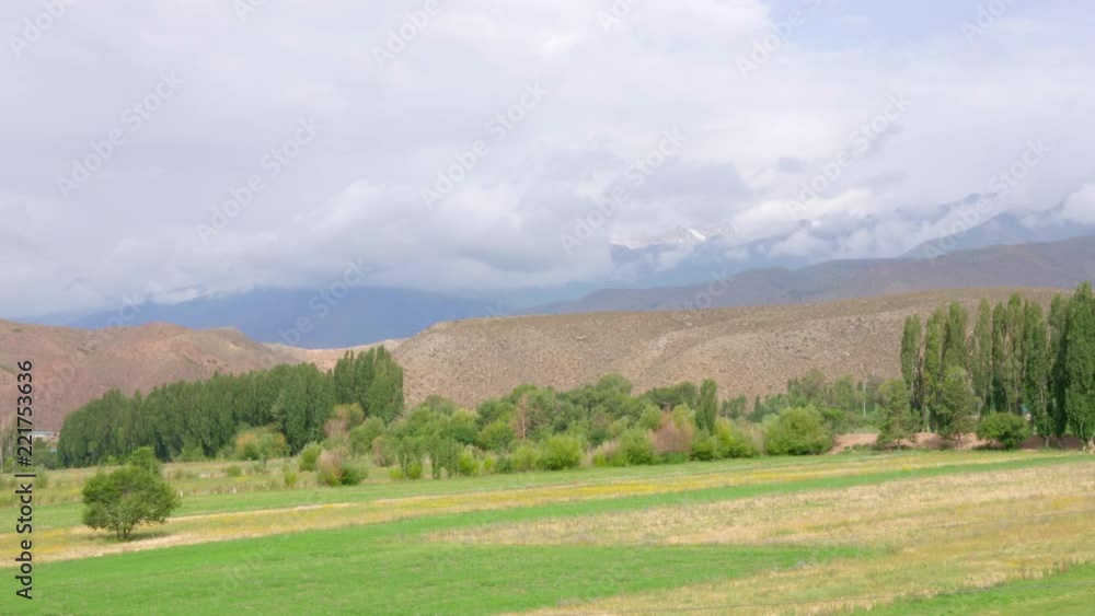 Landscape with empty green meadow, hills and beautiful clouds, timelapse view Landscape with empty green meadow, hills and beautiful clouds, timelapse view