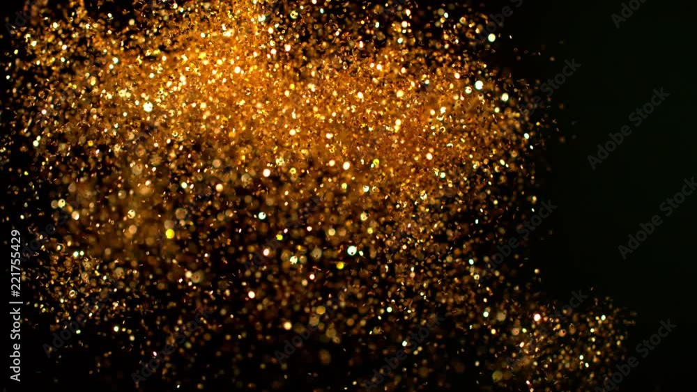 Golden glitter explosion in super slow motion shooted with high speed cinema camera. Golden glitter explosion in super slow motion shooted with high speed cinema camera.