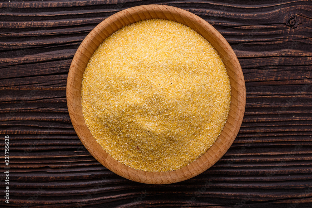 raw Italian corn porridge polenta on a rustic wooden background raw Italian corn porridge polenta on a rustic wooden background