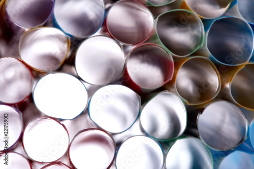 Striped  colored tubes for cocktails. Colorful background.