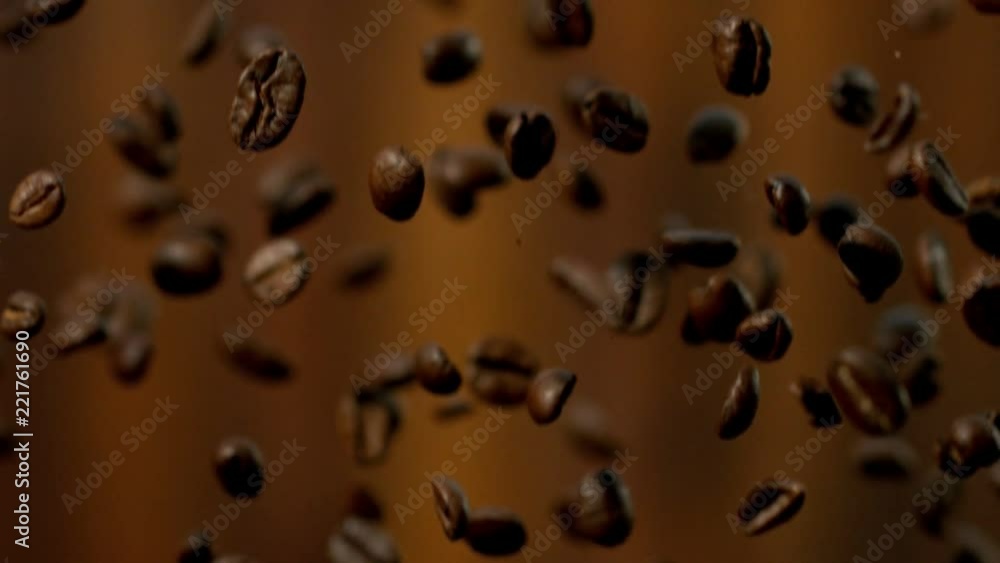 Roasted coffee beans falling down in super slow motion. Shooted with high speed cinema camera. Roasted coffee beans falling down in super slow motion. Shooted with high speed cinema camera.