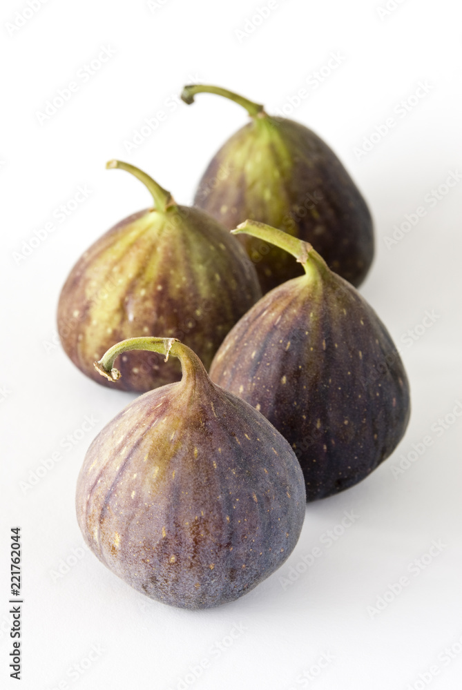 Four fig fruits on a white background. Four fig fruits on a white background.