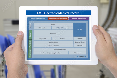 Electronic medical record application on digital tablet screen in hands.
