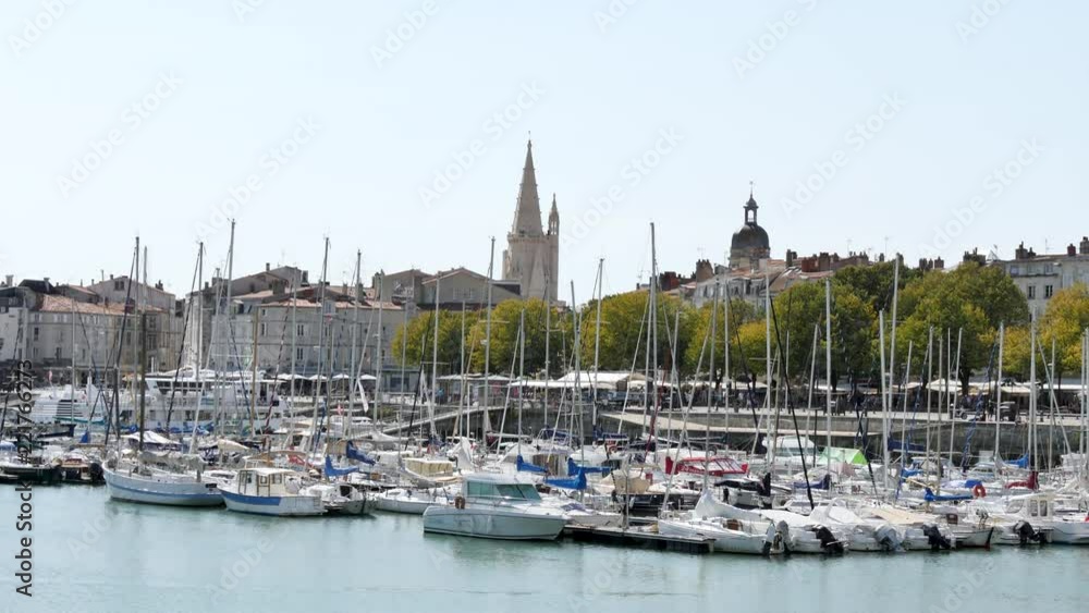 In La Rochelle, a city in western France, during the summer. View of the old port in the city centre. In the background, there are some famous old towers of the city. In La Rochelle, a city in western France, during the summer. View of the old port in the city centre. In the background, there are some famous old towers of the city.