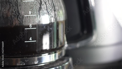 Close up side of a filling coffee pot