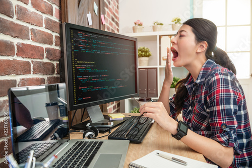 female programmer overworking and yawing photo