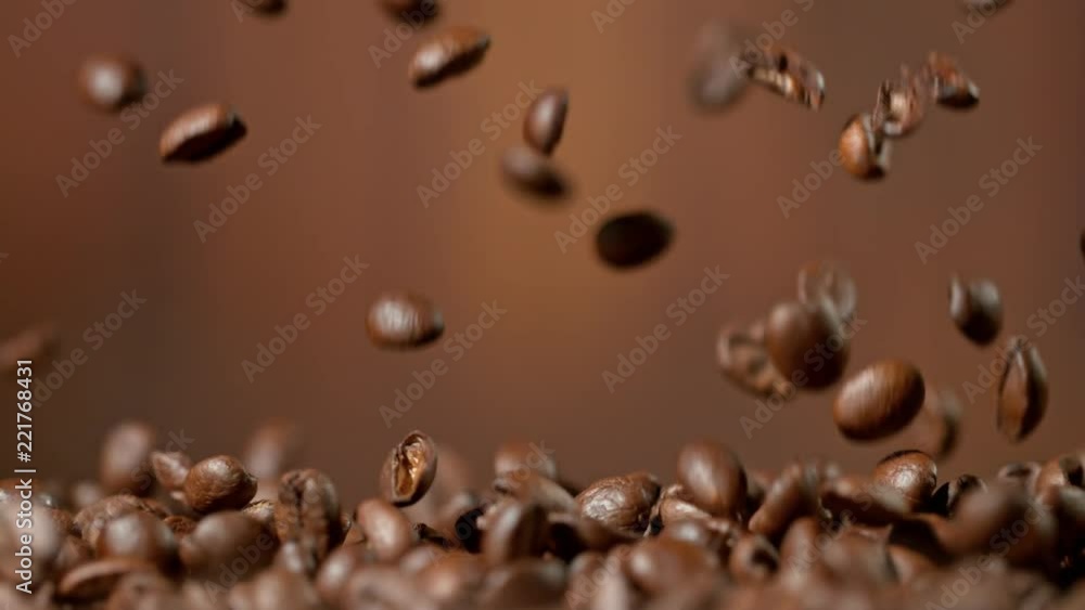 Roasted coffee beans falling down in super slow motion. Shooted with high speed cinema camera. Roasted coffee beans falling down in super slow motion. Shooted with high speed cinema camera.
