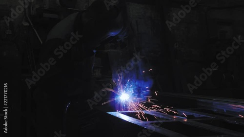 The welder works with metal. Welding of steel. Metal processing. photo