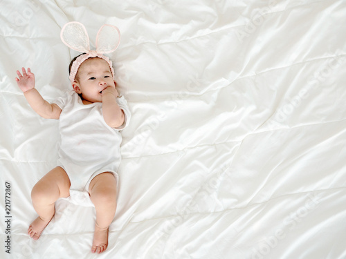 Asian baby girl lying on bedroom.
