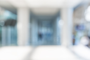 Blur background of businessman walking at corridor in convention hall, business office building hall way background.