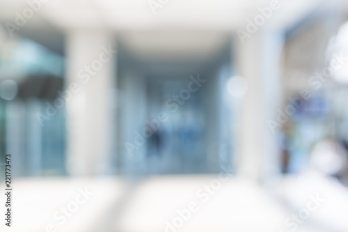 Blur background of businessman walking at corridor in convention hall, business office building hall way background.