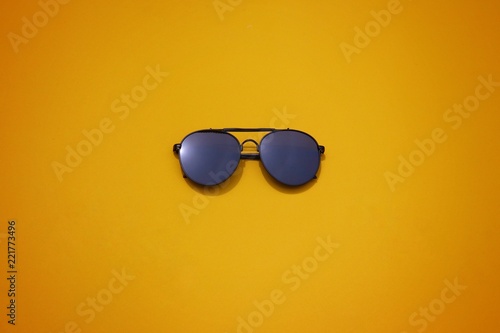 top view sunglasses on colorful background.